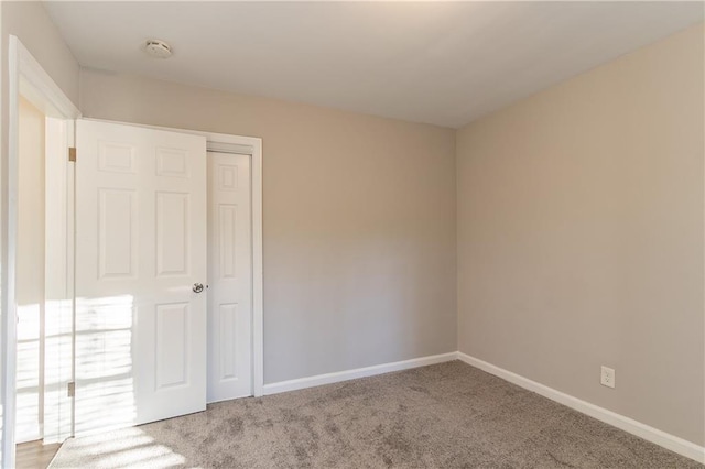 spare room featuring light colored carpet