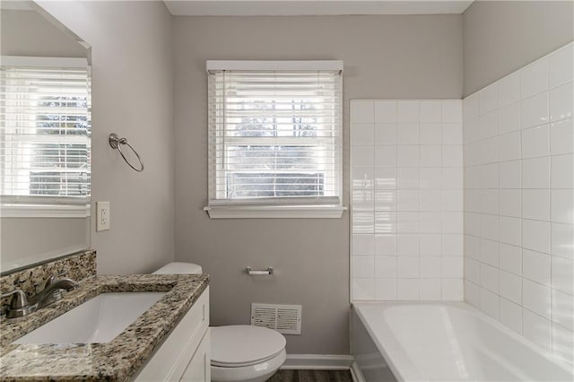 bathroom featuring vanity and toilet