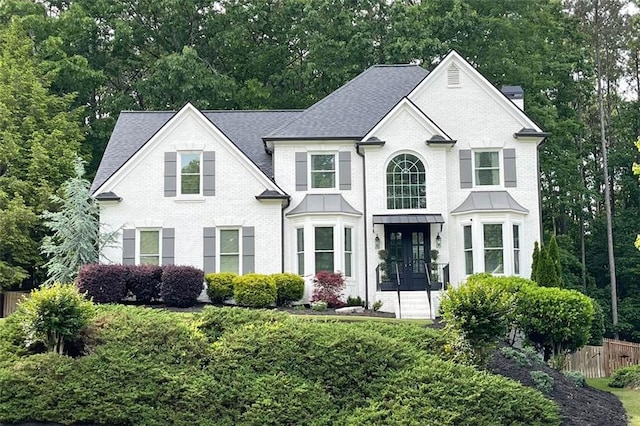 310 Hillpine Dr, Woodstock, GA 30189 - view of front of property featuring brick siding, a shingled roof, and a chimney