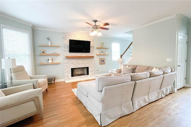 310 Hillpine Dr, Woodstock, GA 30189 - living room with light wood-style flooring, crown molding, a ceiling fan, a fireplace, and stairway