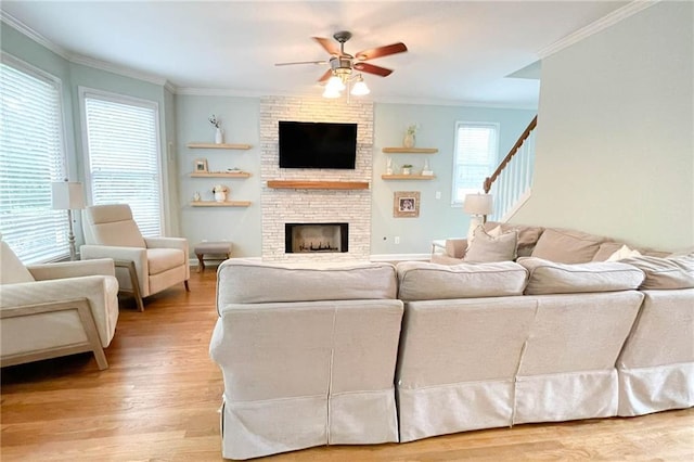 310 Hillpine Dr, Woodstock, GA 30189 - living area with ornamental molding, a ceiling fan, light wood-style flooring, and a large fireplace