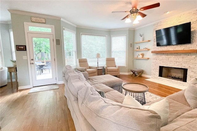310 Hillpine Dr, Woodstock, GA 30189 - living area with wood finished floors, a ceiling fan, baseboards, crown molding, and a fireplace
