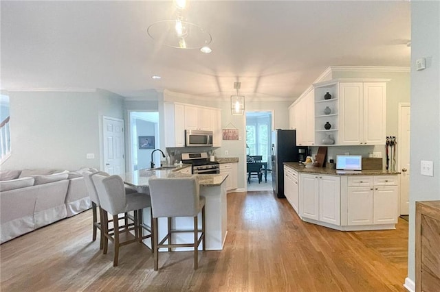 310 Hillpine Dr, Woodstock, GA 30189 - kitchen featuring stainless steel appliances, open shelves, light wood finished floors, white cabinets, and crown molding