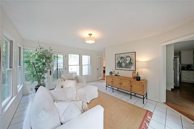 living room with baseboards and light tile patterned floors