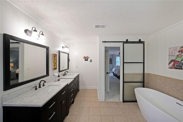 full bath featuring visible vents, a sink, connected bathroom, and crown molding