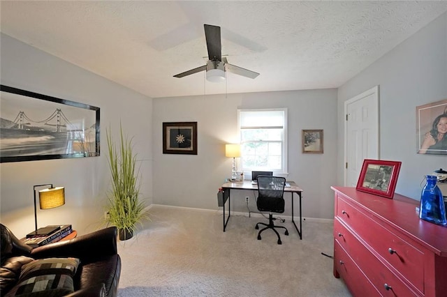 office with baseboards, ceiling fan, and light carpet