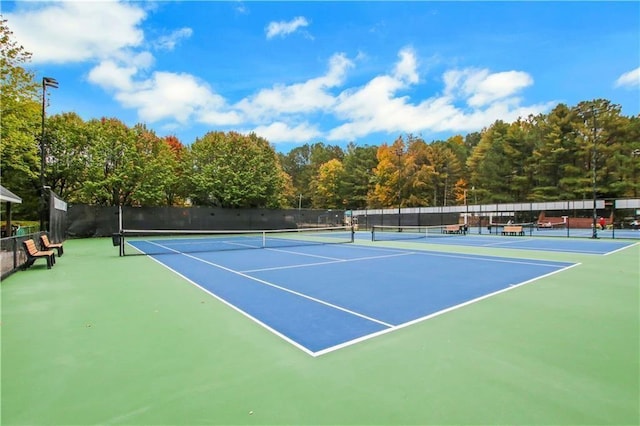view of sport court featuring fence