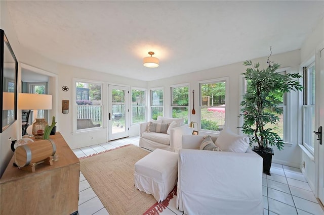 sunroom featuring tile patterned floors and french doors