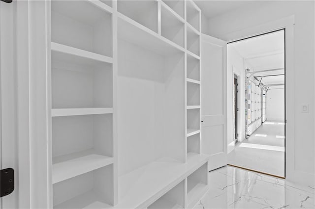 spacious closet with marble finish floor