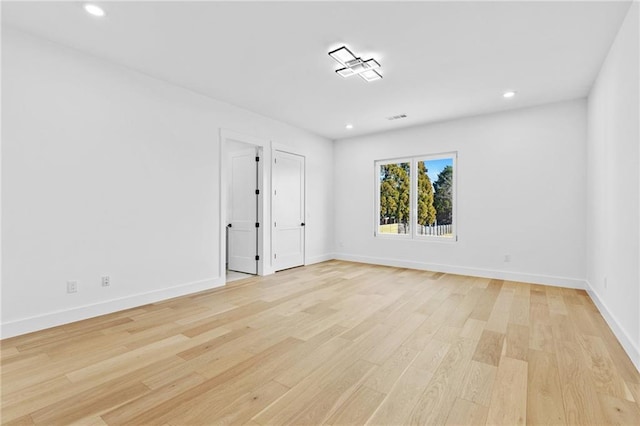 unfurnished room featuring light wood finished floors, recessed lighting, and baseboards