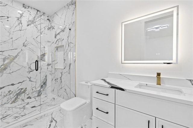 full bathroom featuring a marble finish shower, vanity, and toilet