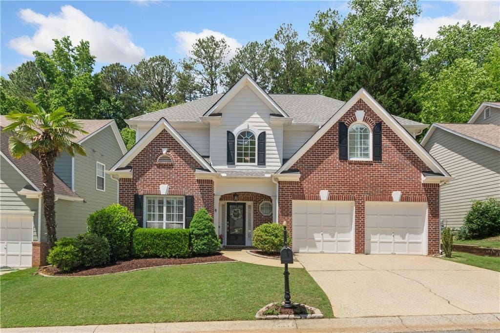 4018 Rhyne Cir SE, Smyrna, GA 30082 - traditional-style home featuring brick siding, concrete driveway, a front yard, and an attached garage