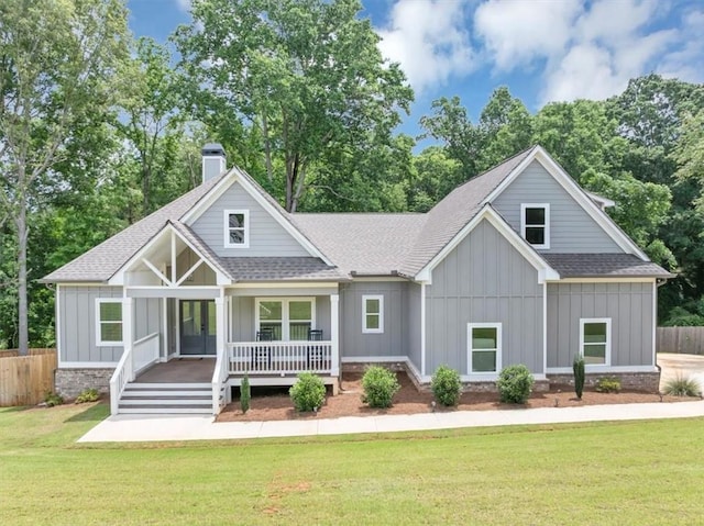 1021 Windsor Creek Dr, Madison, GA 30650 - view of front of property featuring board and batten siding, roof with shingles, a chimney, and french doors