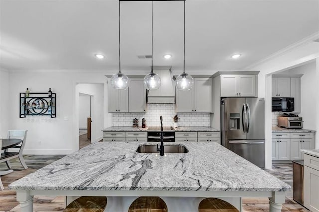 1021 Windsor Creek Dr, Madison, GA 30650 - kitchen featuring stainless steel refrigerator with ice dispenser, crown molding, a breakfast bar area, backsplash, and pendant lighting