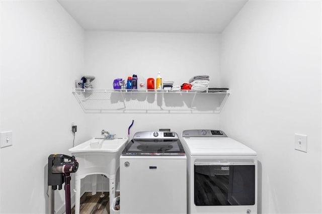 1021 Windsor Creek Dr, Madison, GA 30650 - washroom featuring washing machine and clothes dryer and wood finished floors