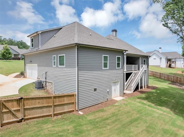 1021 Windsor Creek Dr, Madison, GA 30650 - rear view of house with stairs, concrete driveway, a shingled roof, and a chimney