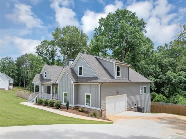 1021 Windsor Creek Dr, Madison, GA 30650 - view of front of home featuring board and batten siding, covered porch, roof with shingles, concrete driveway, and an attached garage