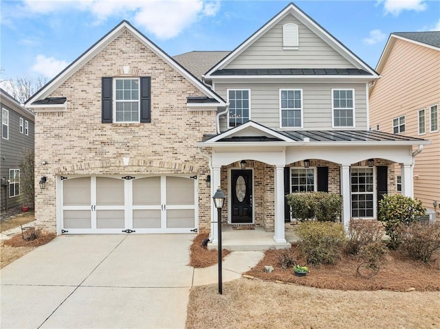 view of property with a garage and covered porch