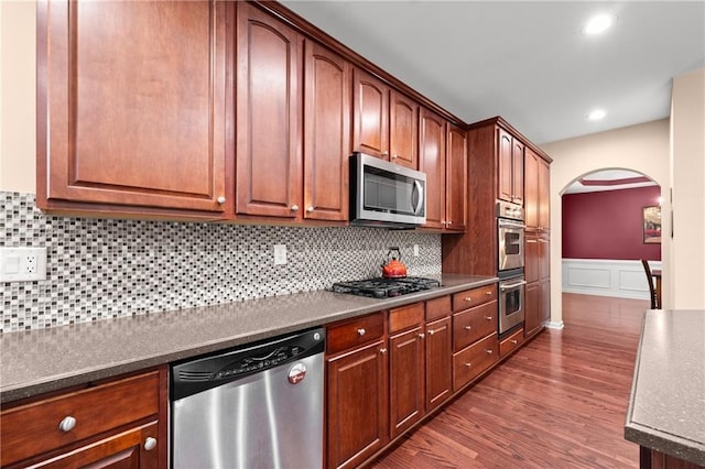 kitchen featuring backsplash, dark hardwood / wood-style floors, and appliances with stainless steel finishes