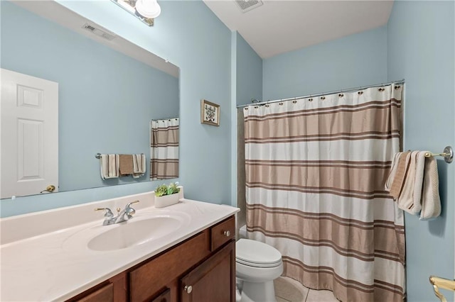 bathroom featuring tile patterned floors, vanity, and toilet