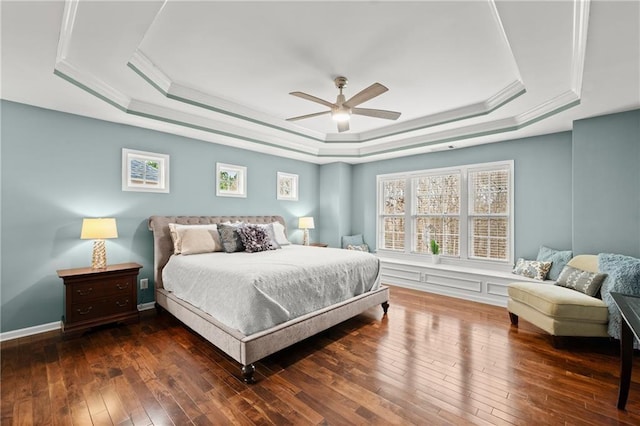 bedroom featuring ceiling fan, ornamental molding, dark hardwood / wood-style floors, and a raised ceiling