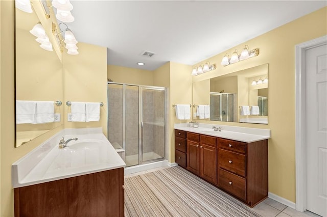 bathroom featuring tile patterned flooring, vanity, and walk in shower