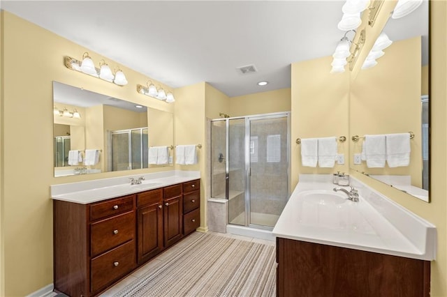 bathroom with walk in shower, tile patterned floors, and vanity