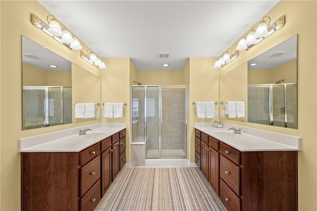 bathroom featuring vanity, tile patterned floors, and a shower with shower door