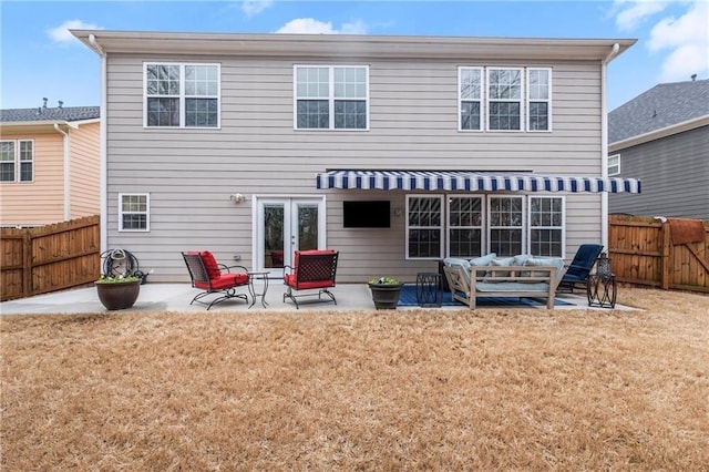 rear view of property featuring a yard, an outdoor hangout area, and a patio area