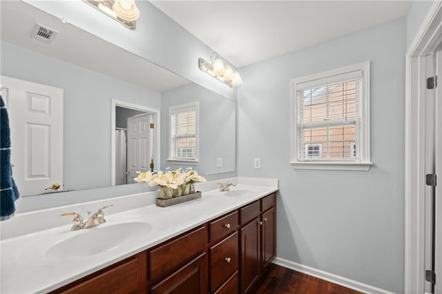 bathroom with vanity and hardwood / wood-style floors