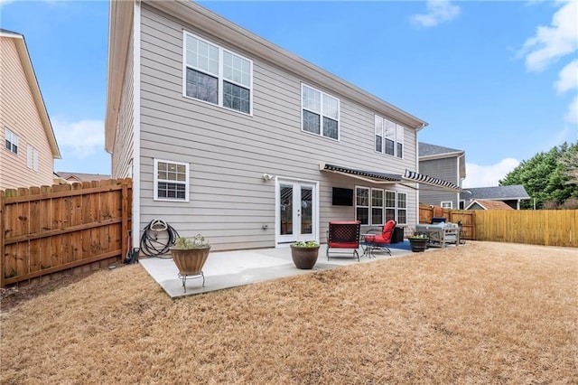 back of house with french doors, a yard, and a patio area