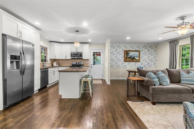 1630 Park Ln, Marietta, GA 30066 - kitchen with stainless steel appliances, open floor plan, dark wood-style floors, dark countertops, and white cabinetry