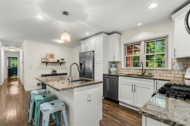 1630 Park Ln, Marietta, GA 30066 - kitchen with appliances with stainless steel finishes, a sink, dark stone counters, ornamental molding, and decorative backsplash
