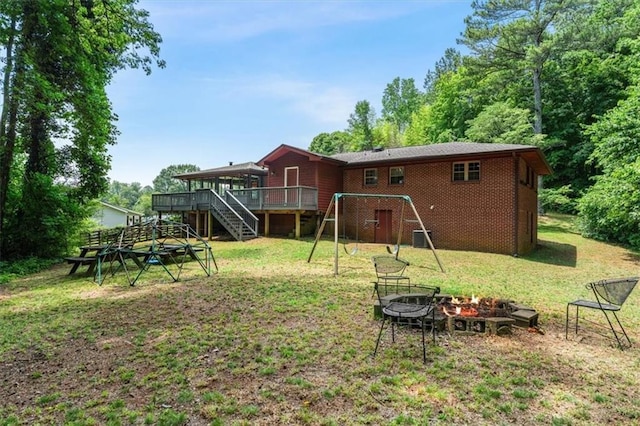 1630 Park Ln, Marietta, GA 30066 - rear view of house with a fire pit, stairway, a wooden deck, a yard, and brick siding