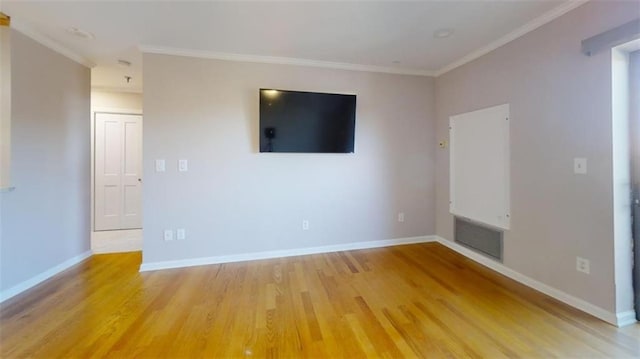 unfurnished room featuring light hardwood / wood-style floors and crown molding