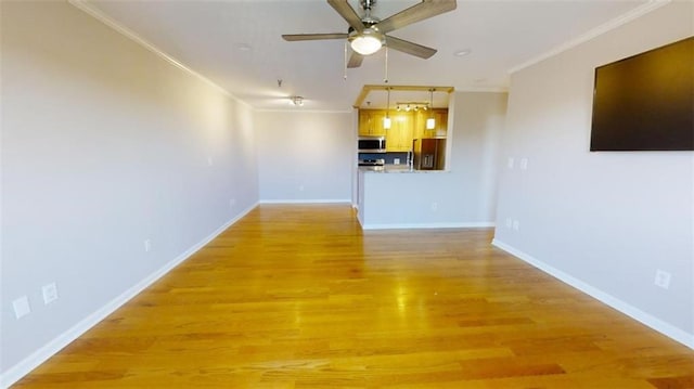 unfurnished living room featuring hardwood / wood-style floors, ceiling fan, and crown molding