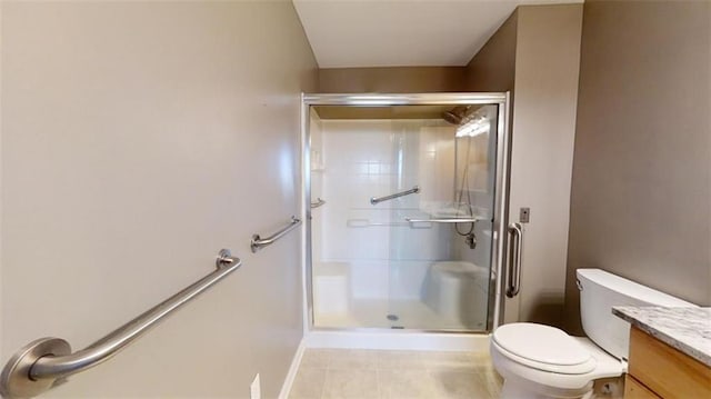 bathroom with vanity, toilet, and a shower with shower door