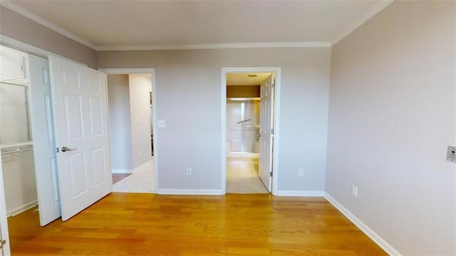 unfurnished bedroom featuring ornamental molding and hardwood / wood-style flooring