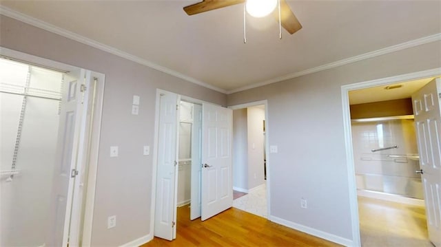 unfurnished bedroom featuring ceiling fan, light hardwood / wood-style floors, and ornamental molding