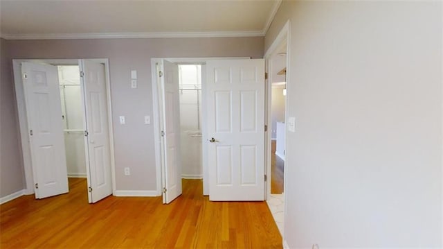 unfurnished bedroom featuring light hardwood / wood-style flooring and ornamental molding