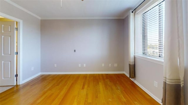 spare room with hardwood / wood-style flooring and ornamental molding