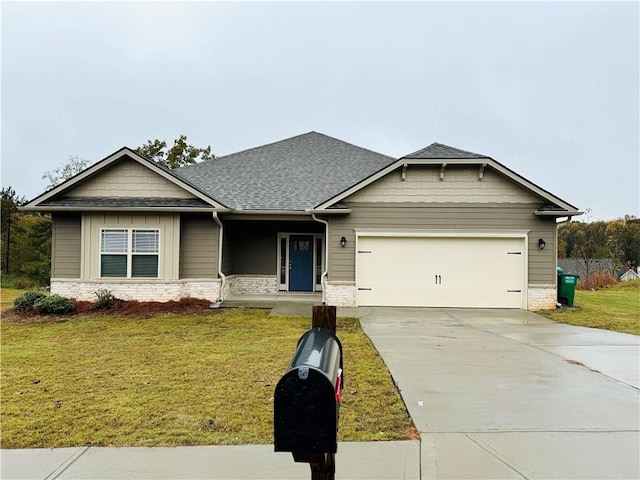 craftsman inspired home with a front yard and a garage