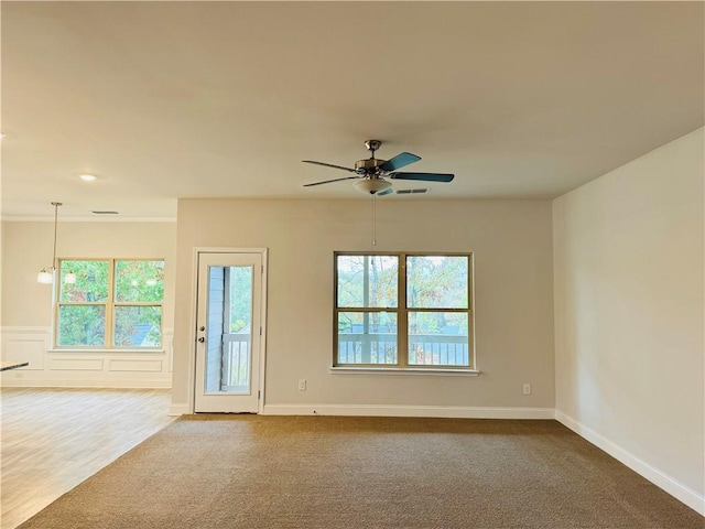 spare room featuring carpet flooring and ceiling fan with notable chandelier