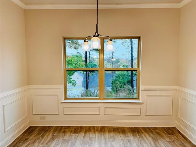 interior details with hardwood / wood-style flooring, a notable chandelier, and crown molding