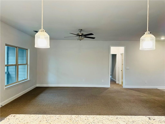 spare room featuring ceiling fan and carpet