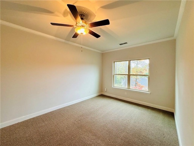 spare room featuring carpet, ceiling fan, and crown molding