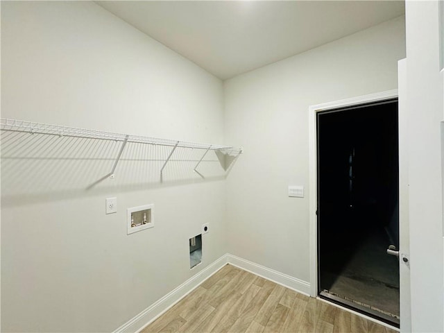 washroom with electric dryer hookup, hookup for a washing machine, and light hardwood / wood-style floors