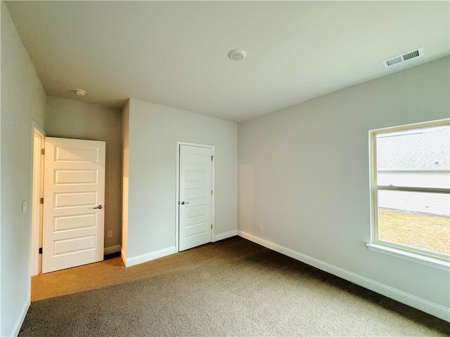 unfurnished bedroom with carpet and a closet