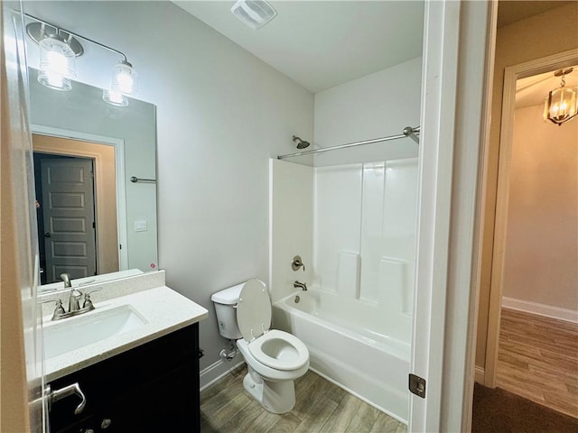 full bathroom featuring wood-type flooring, vanity, shower / bath combination, and toilet