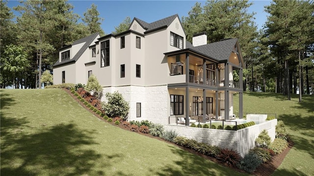 back of house with a lawn, a balcony, and a patio